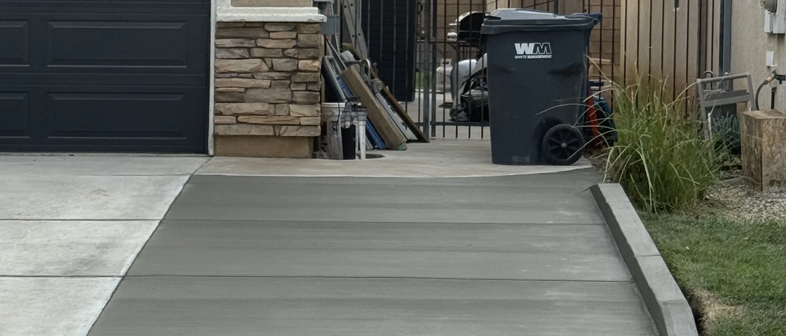 Finished driveway apron running between two houses to the street