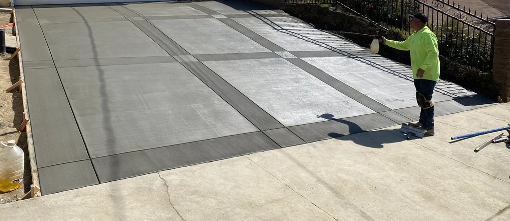 Broom finish: fine parallel texture pulled across a fresh driveway slab
