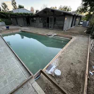 A pool and its surrounding concrete deck