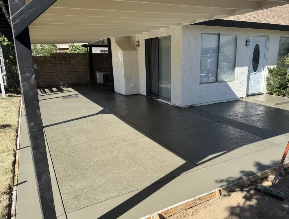 Day 4: the finished patio, smooth grey slab with a dark banded border